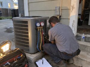 Refrigerant gauge check on an outdoor AC condenser by Lexington Heating and Air