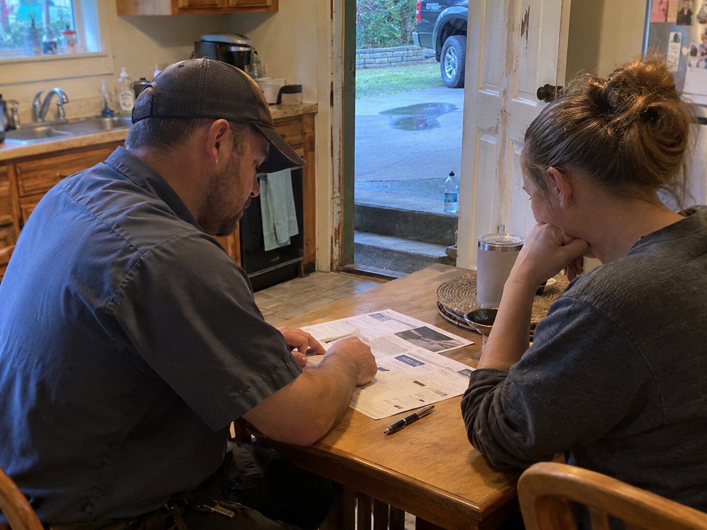 Reviewing financing options at a kitchen table by Lexington Heating and Air