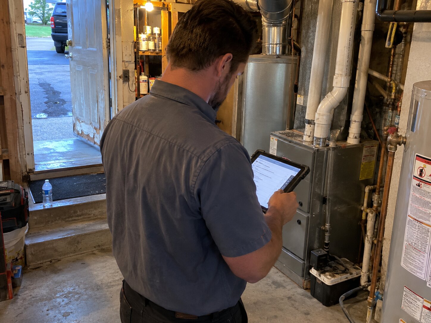 Residential HVAC maintenance walkthrough with a tablet checklist in Maintenance by Lexington Heating and Air